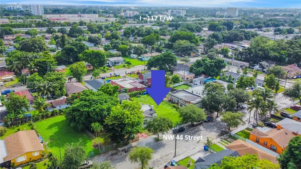 an aerial view of a houses with a yard