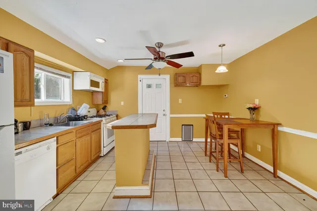 a kitchen with stainless steel appliances a sink a counter top space and cabinets