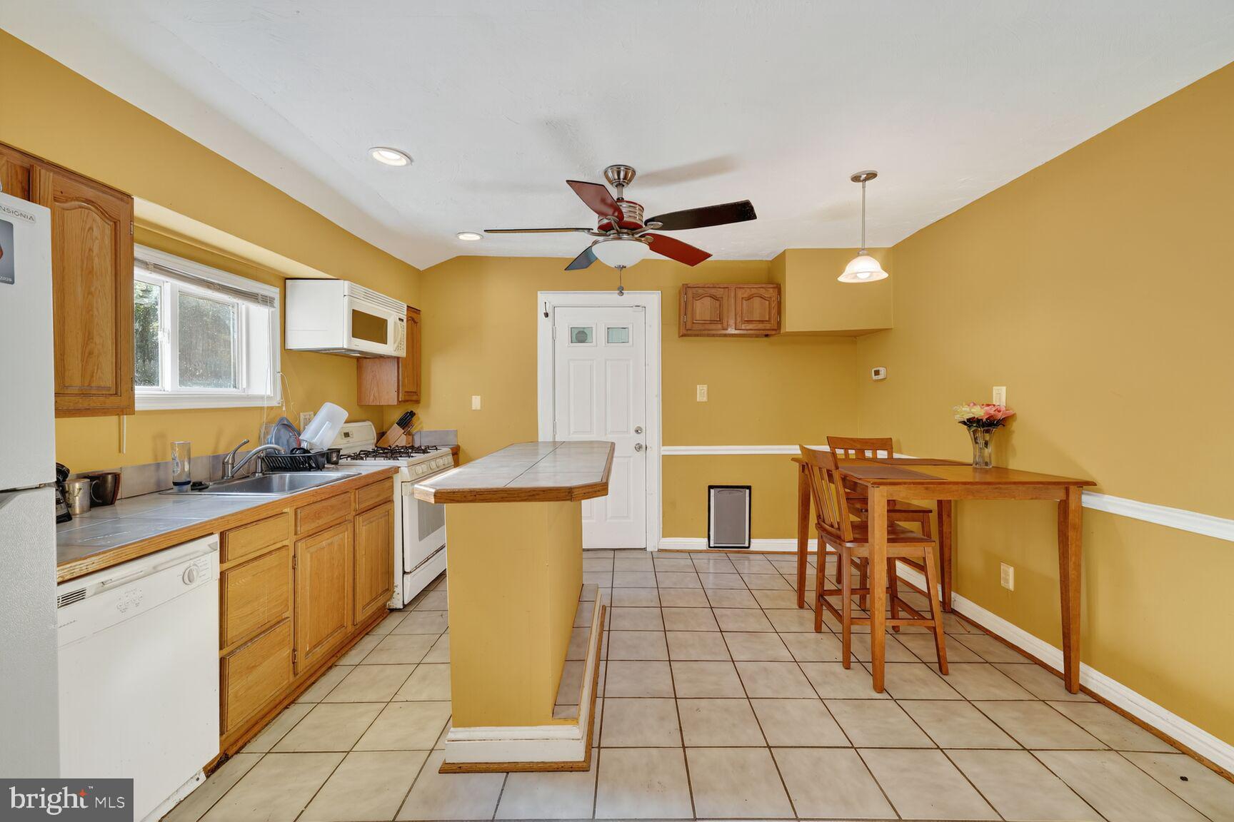a kitchen with stainless steel appliances a sink a counter top space and cabinets