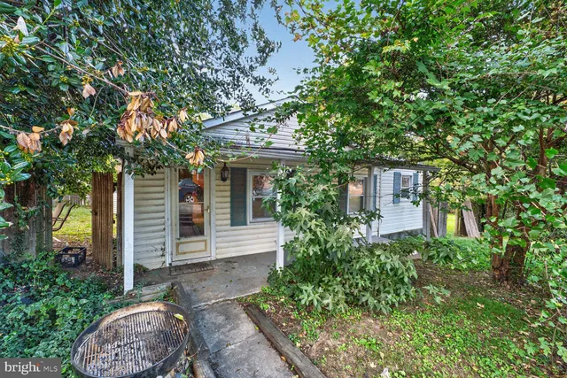 front view of a house with a tree