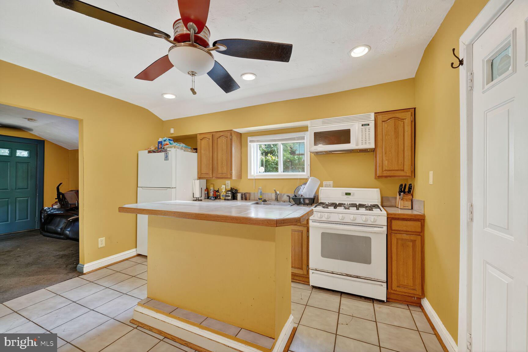1001 Iago Avenue Capitol Heights, MD 20743 - Photo 2 of 13 a kitchen with a stove and a refrigerator