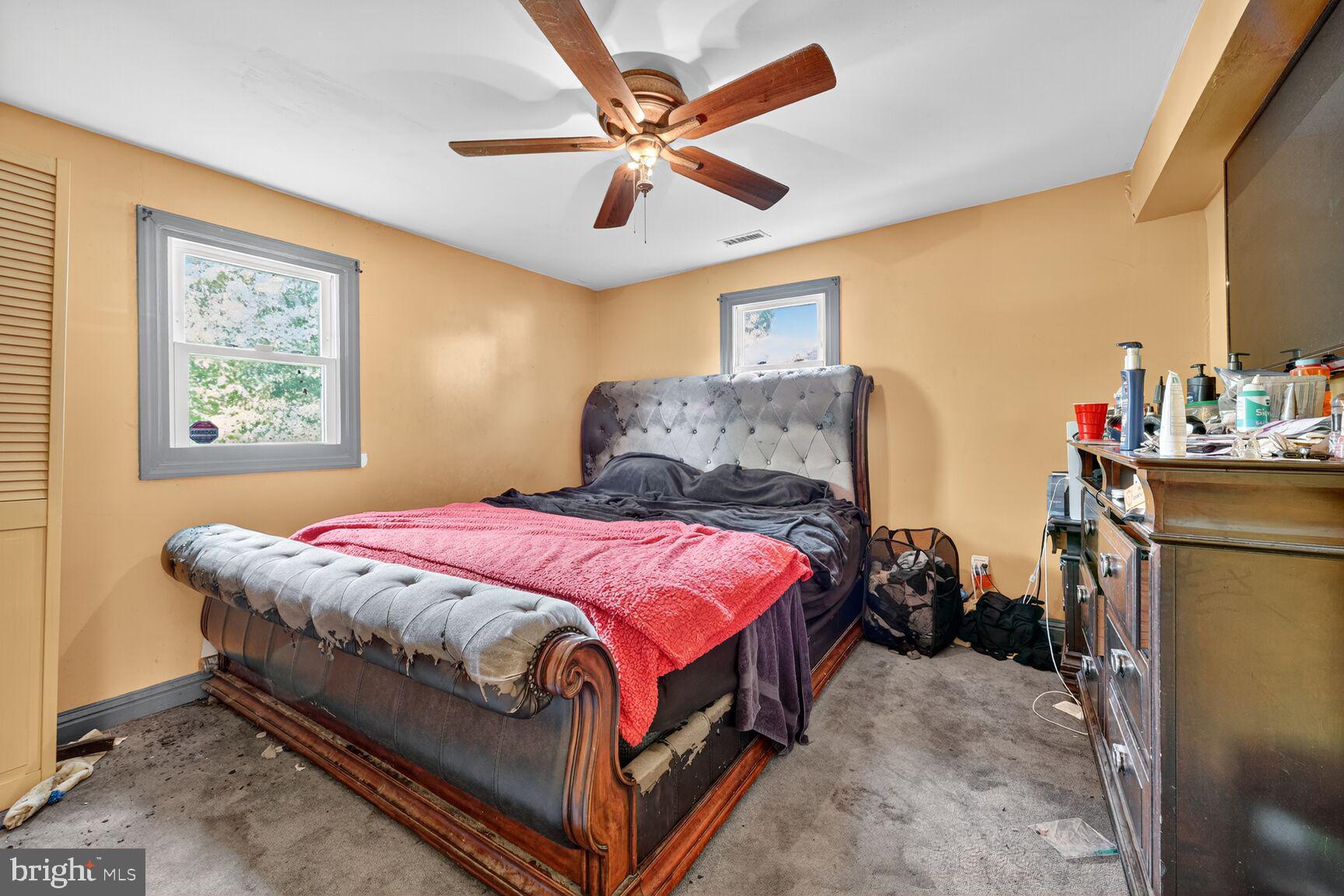 1001 Iago Avenue Capitol Heights, MD 20743 - Photo 7 of 13 a bedroom with a bed a ceiling fan and a large window