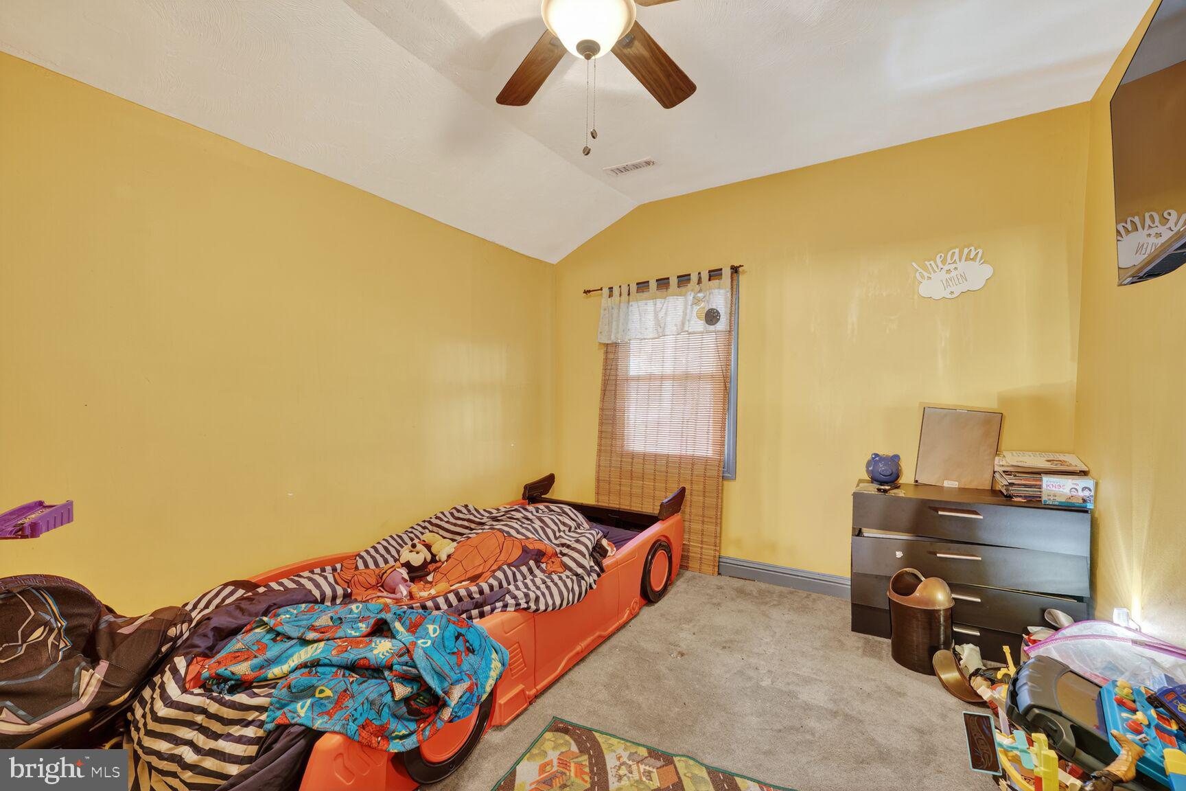 1001 Iago Avenue Capitol Heights, MD 20743 - Photo 10 of 13 a bedroom with a bed and a chandelier