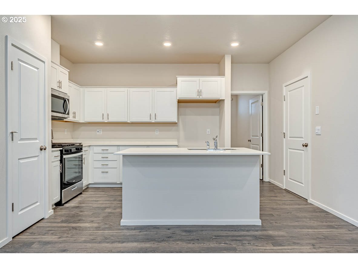2897 U Street Springfield, OR 97477 - Photo 11 of 26 a kitchen with cabinets and wooden floor