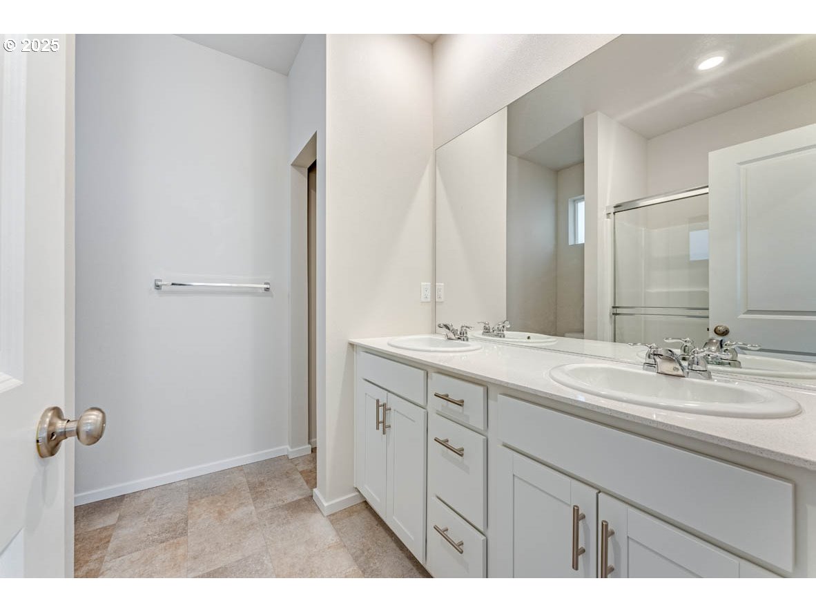 2897 U Street Springfield, OR 97477 - Photo 24 of 26 a bathroom with a double vanity sink and mirror