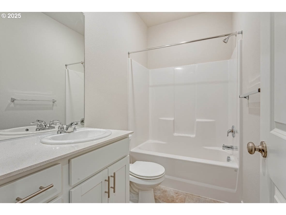 2897 U Street Springfield, OR 97477 - Photo 5 of 26 a bathroom with a sink a toilet and shower