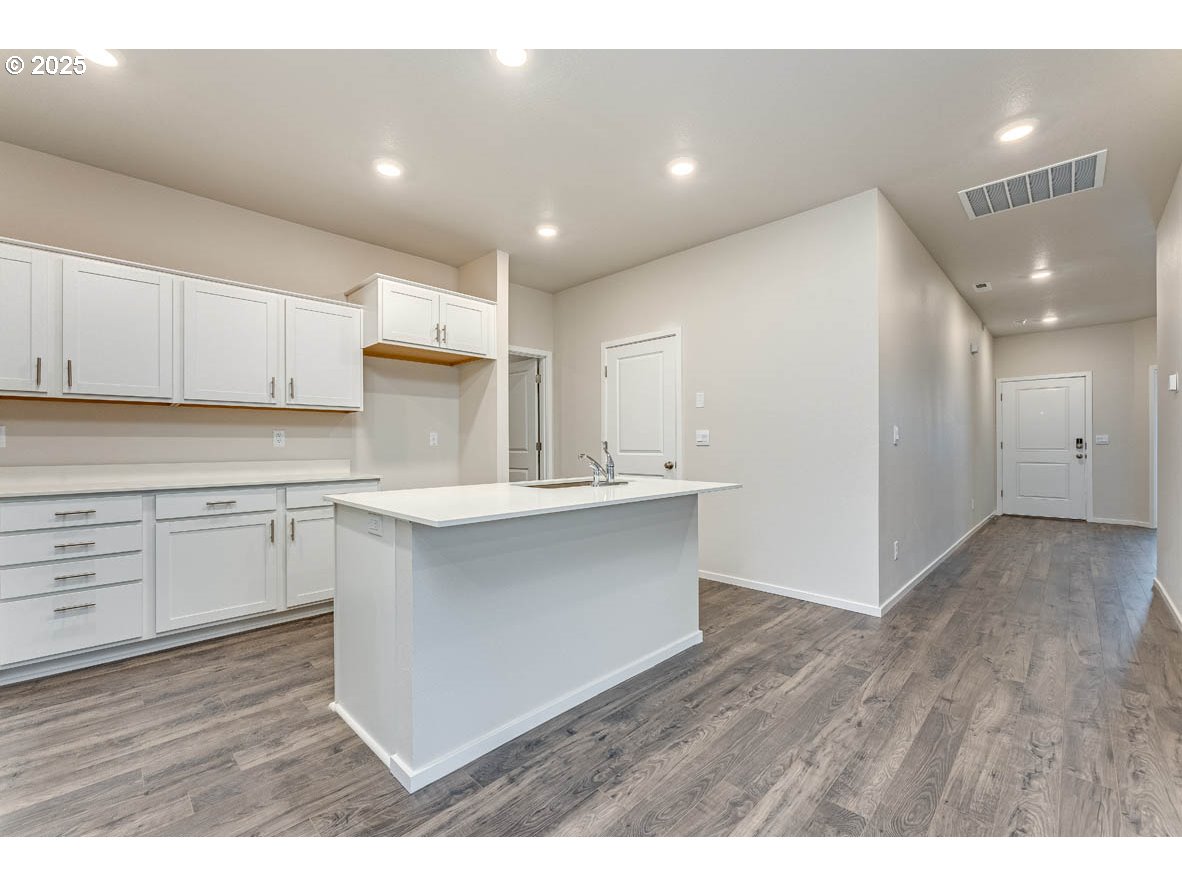 2897 U Street Springfield, OR 97477 - Photo 10 of 26 a kitchen with a refrigerator and white cabinets