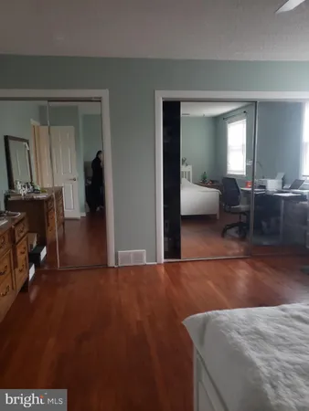 a bathroom with a toilet a sink and a mirror