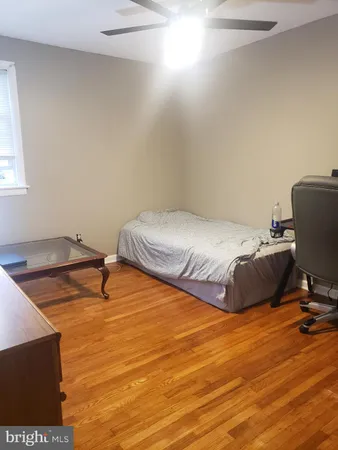 a bedroom with a bed and a ceiling fan