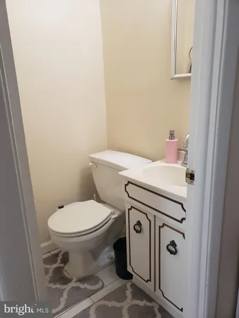 a white toilet sitting next to a bathroom sink