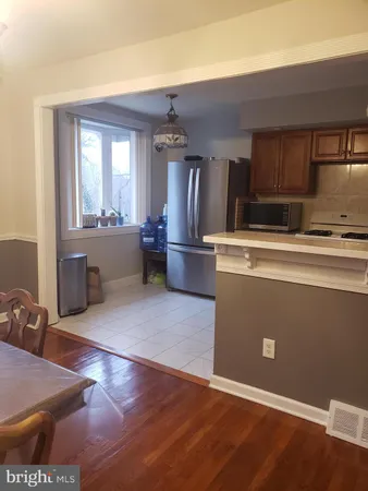 a view of kitchen with furniture and wooden floor