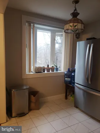 a kitchen with a refrigerator and windows