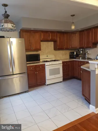 a kitchen with stainless steel appliances granite countertop a stove a sink dishwasher and a refrigerator