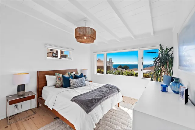 a bedroom with a large bed and a large window