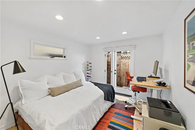 a bedroom with a bed and a desk