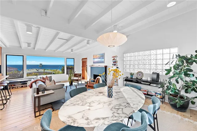 a living room with fireplace furniture and a large window