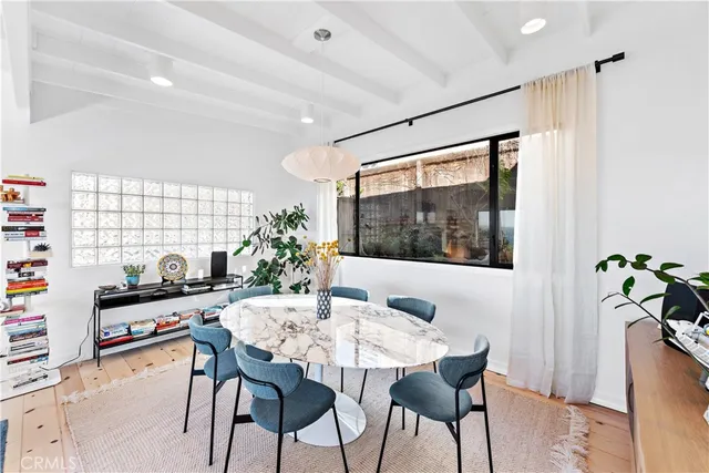 a dining room with furniture and window