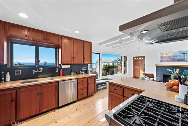 a kitchen with stainless steel appliances granite countertop a sink stove and cabinets