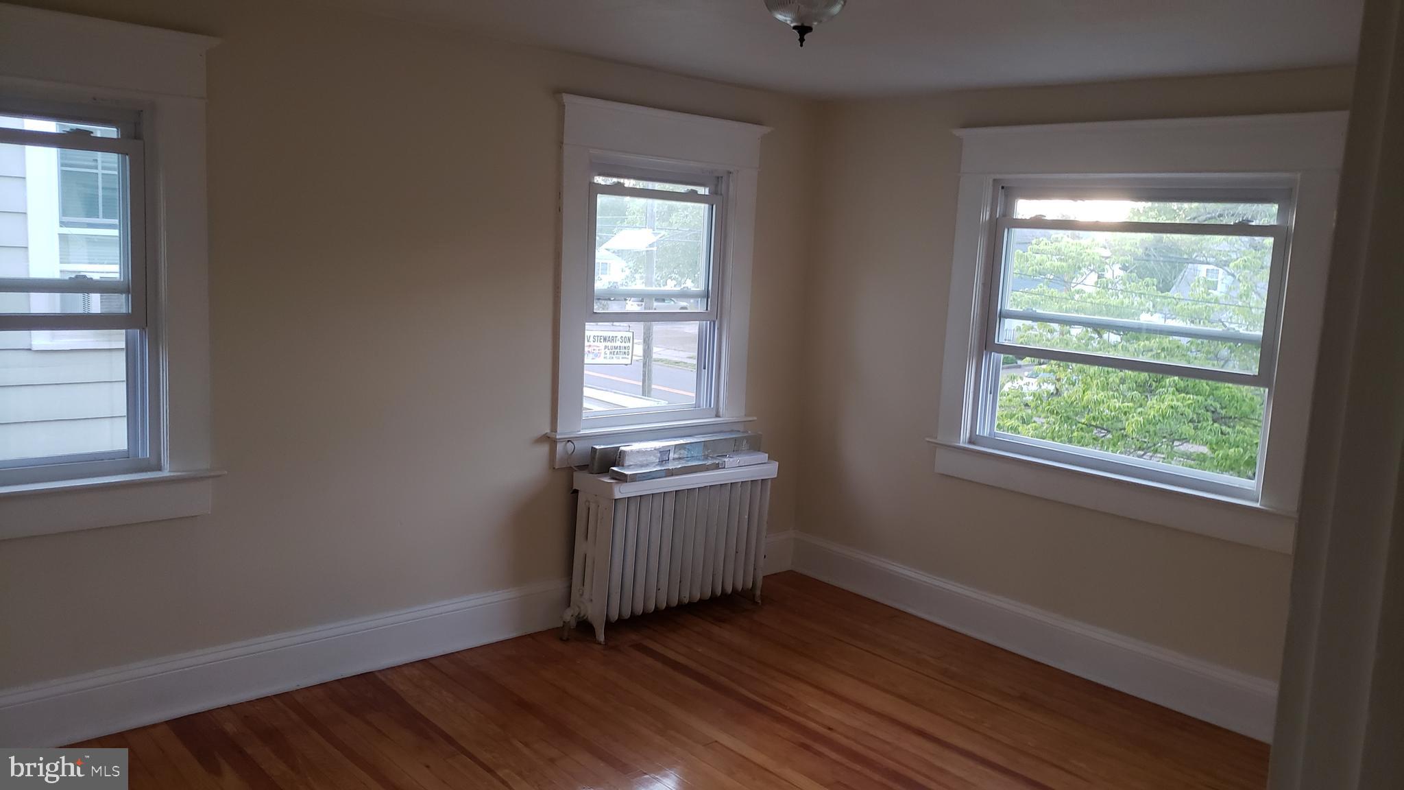 2931 Nottingham Way Hamilton, NJ 08619 - Photo 12 of 19 a view of an empty room with wooden floor and a window