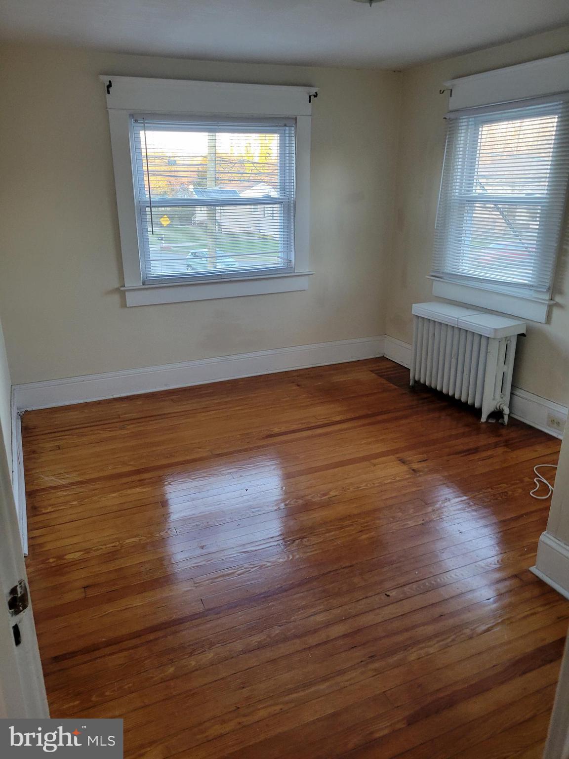 2931 Nottingham Way Hamilton, NJ 08619 - Photo 13 of 19 a view of an empty room with wooden floor and a window