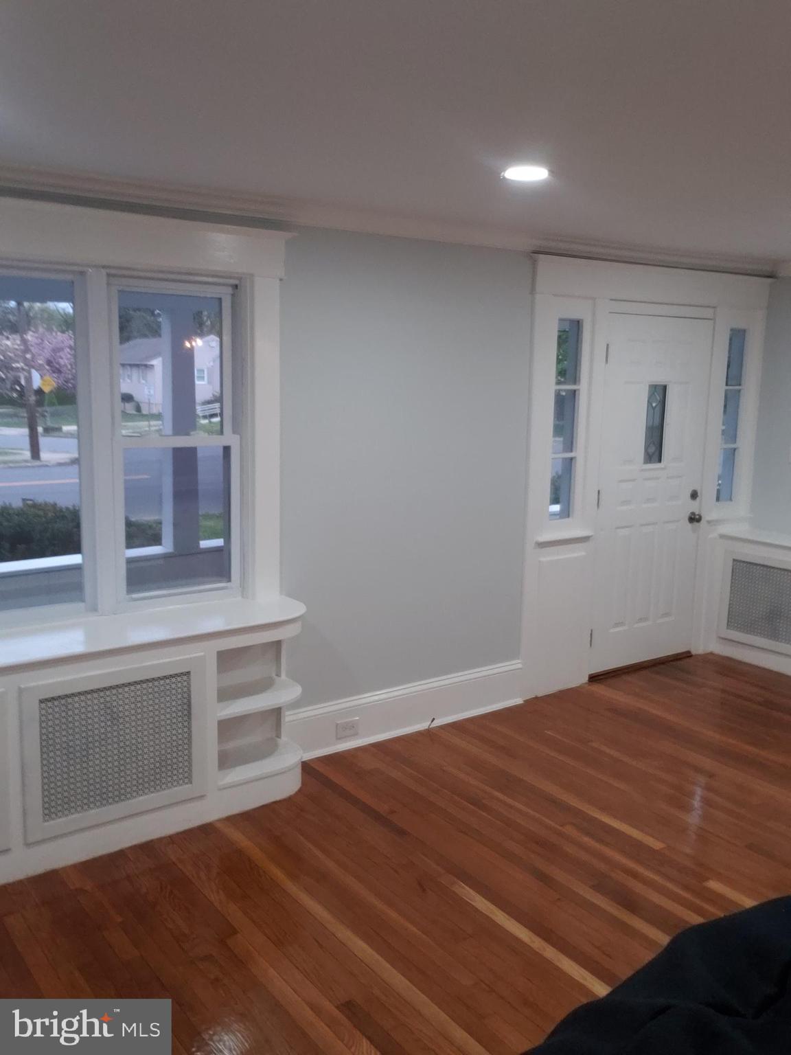 2931 Nottingham Way Hamilton, NJ 08619 - Photo 4 of 19 a view of an empty room with a window and wooden floor