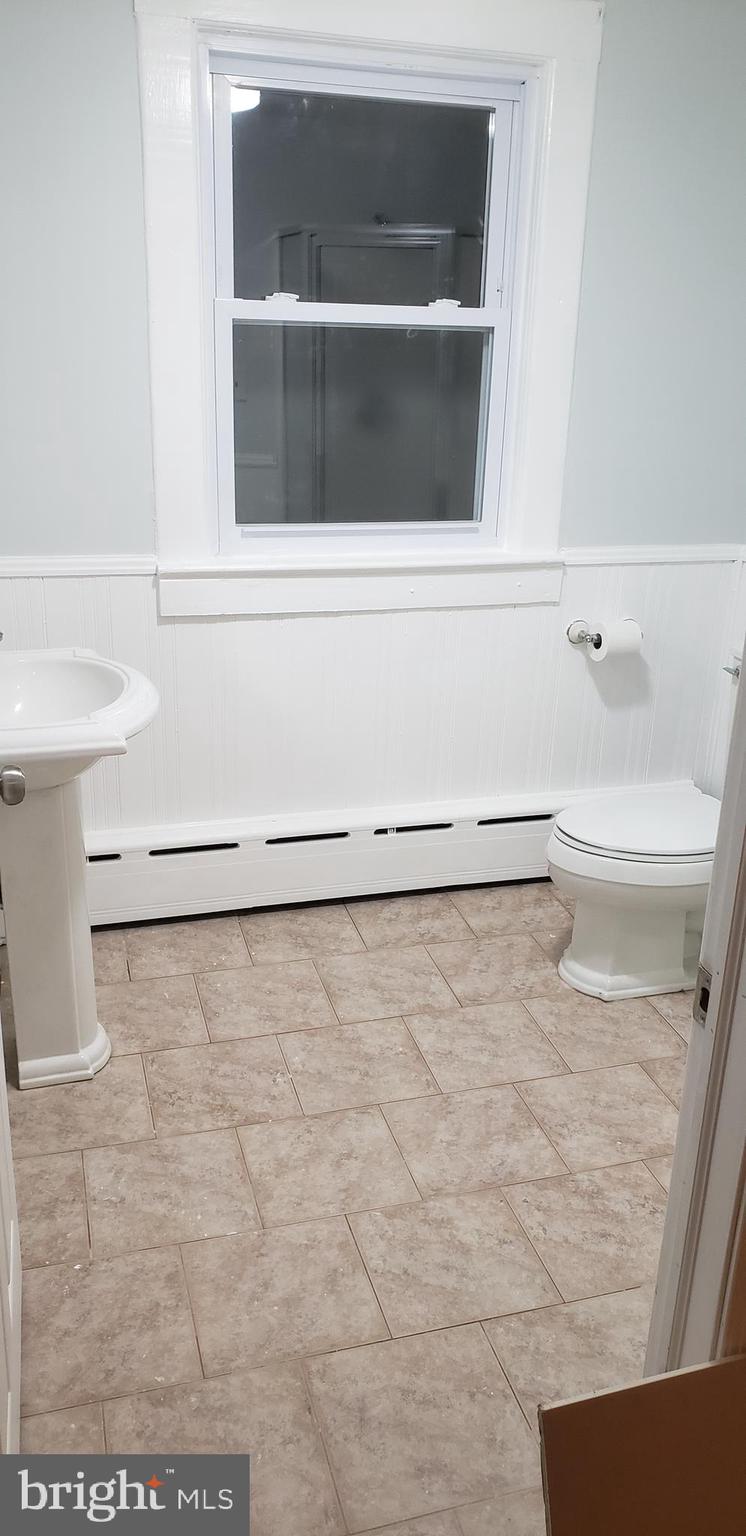 2931 Nottingham Way Hamilton, NJ 08619 - Photo 6 of 19 a bathroom with a white toilet and a shower