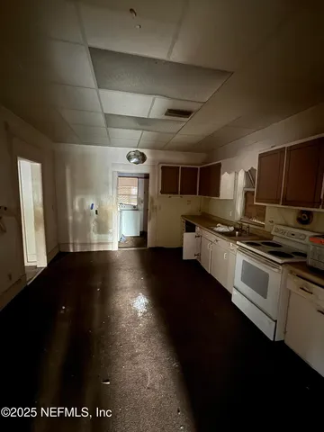 a view of kitchen with microwave and cabinets