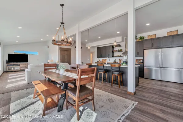 a large white kitchen with stainless steel appliances lots of counter top space