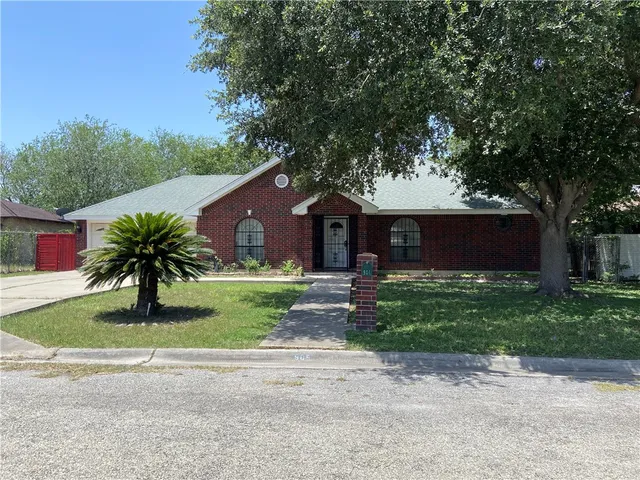 a front view of a house with a yard and a garage