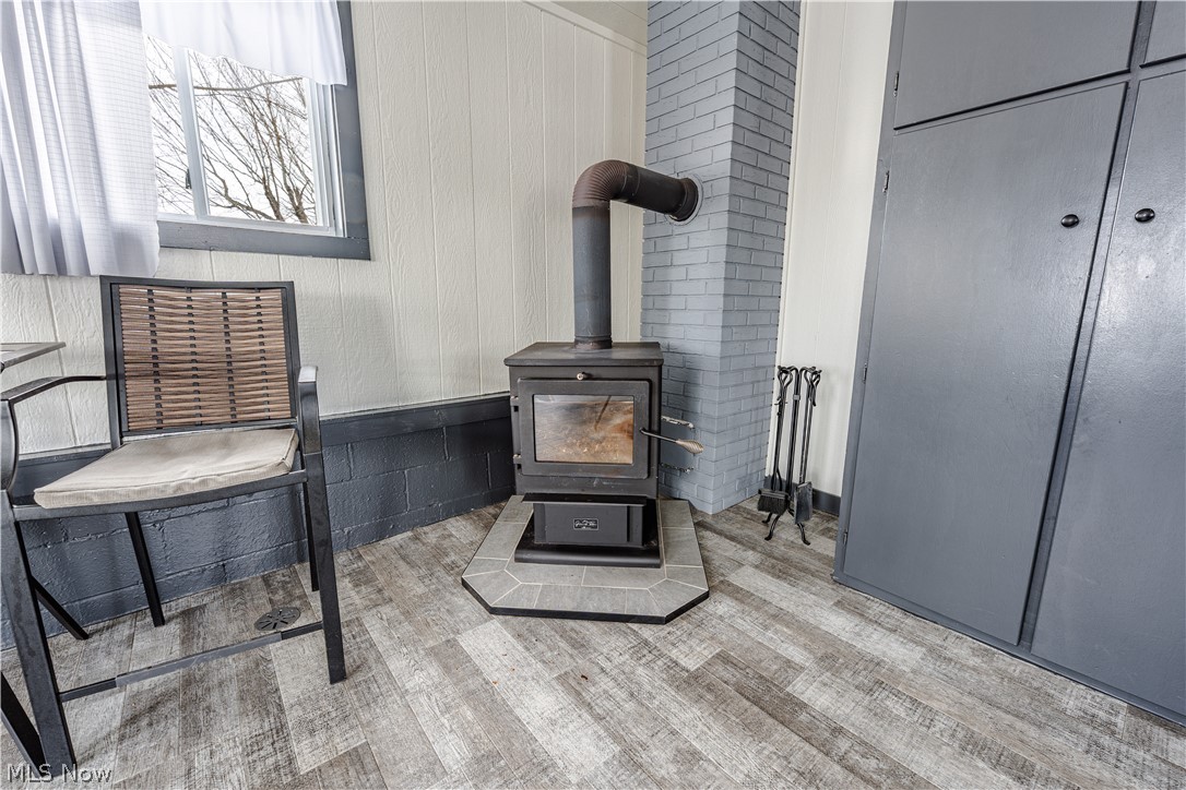 16350 Nauvoo Road Middlefield, OH 44062 - Photo 48 of 50 Detailed view of wood finished floors and a wood stove