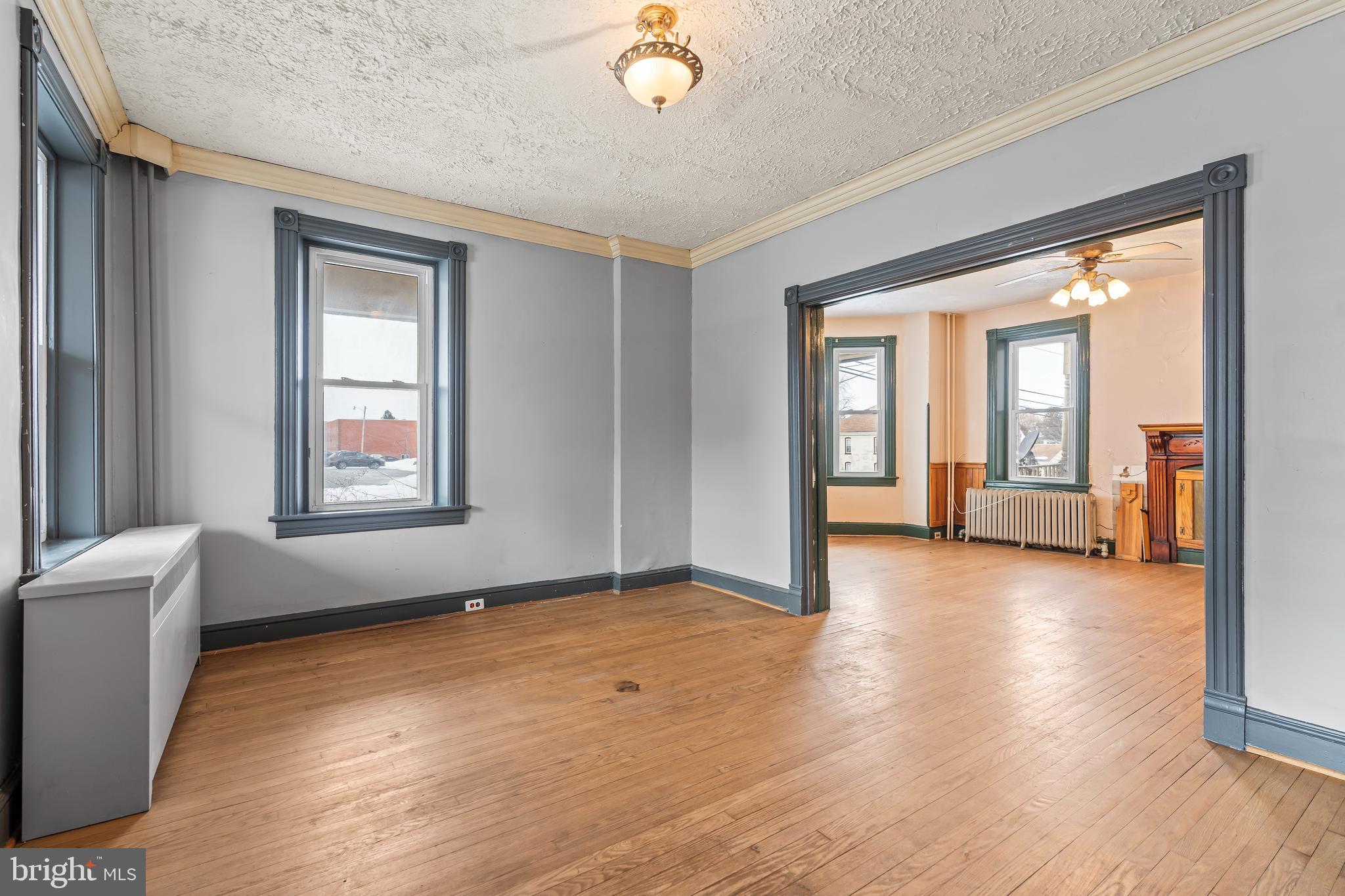 767 Spruce Street Hagerstown, MD 21740 - Photo 11 of 36 a view of an empty room with a window and wooden floor