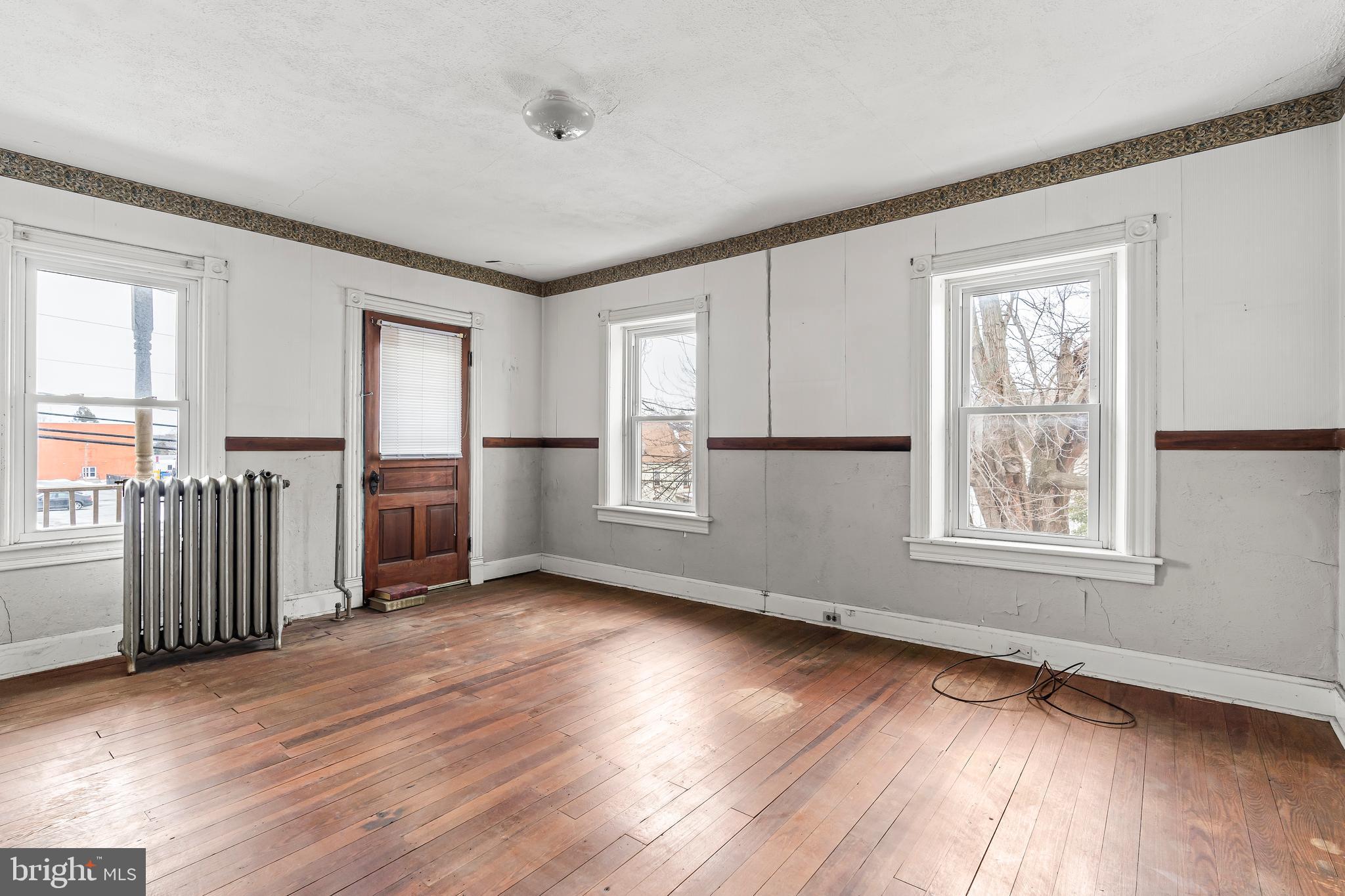 767 Spruce Street Hagerstown, MD 21740 - Photo 15 of 36 an empty room with wooden floor and windows