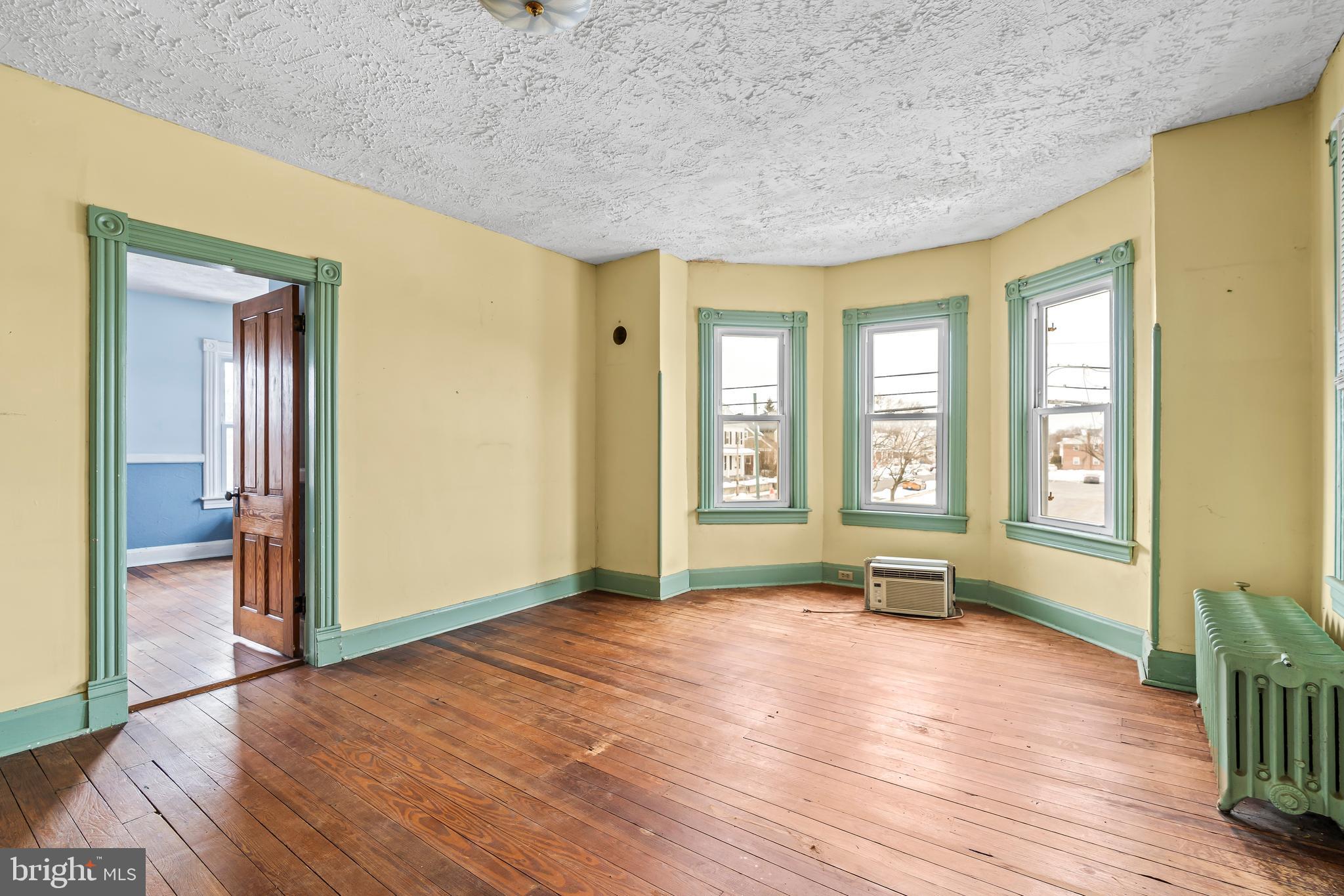 767 Spruce Street Hagerstown, MD 21740 - Photo 17 of 36 an empty room with wooden floor and windows