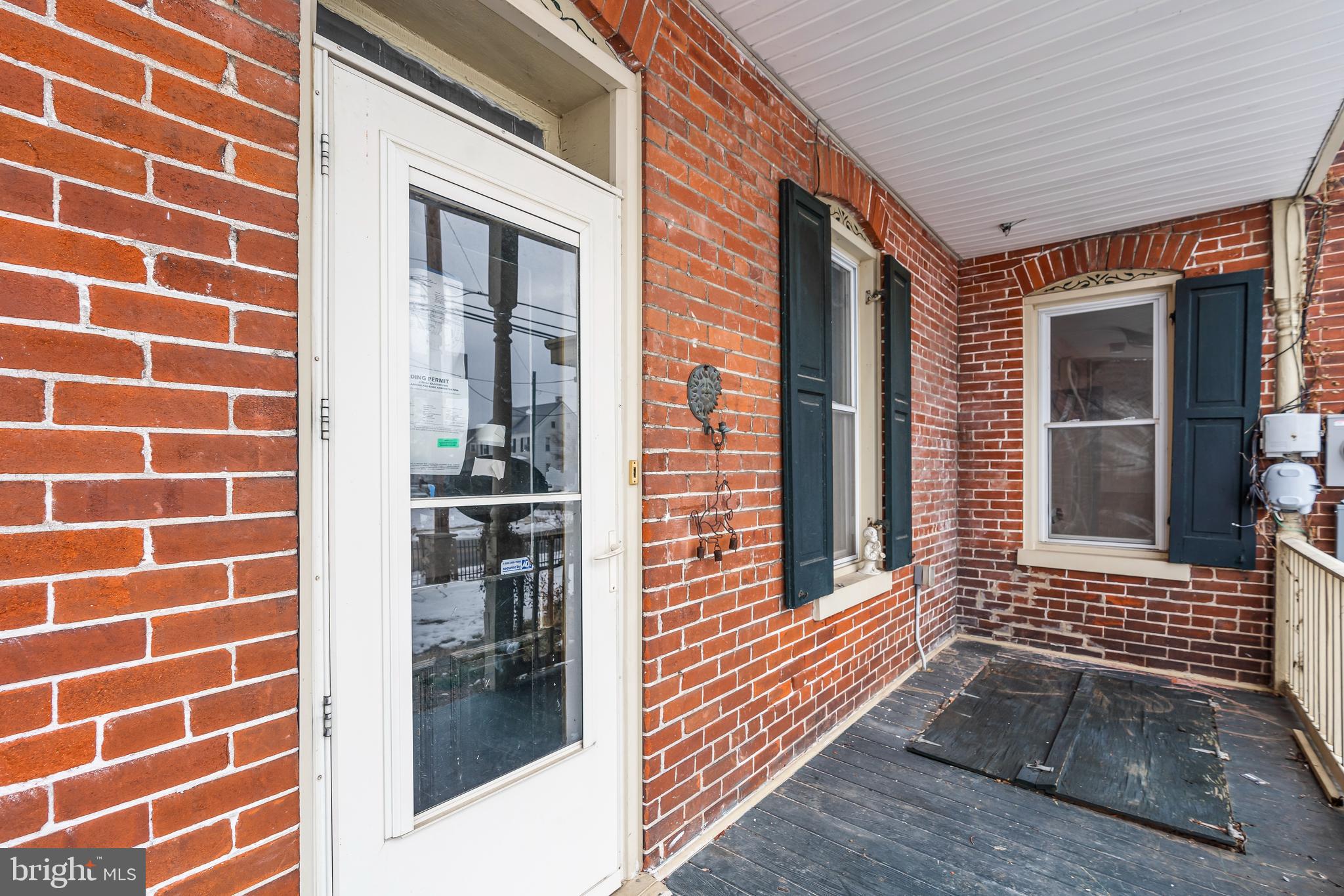 767 Spruce Street Hagerstown, MD 21740 - Photo 22 of 36 a view of a brick house with a door and a window
