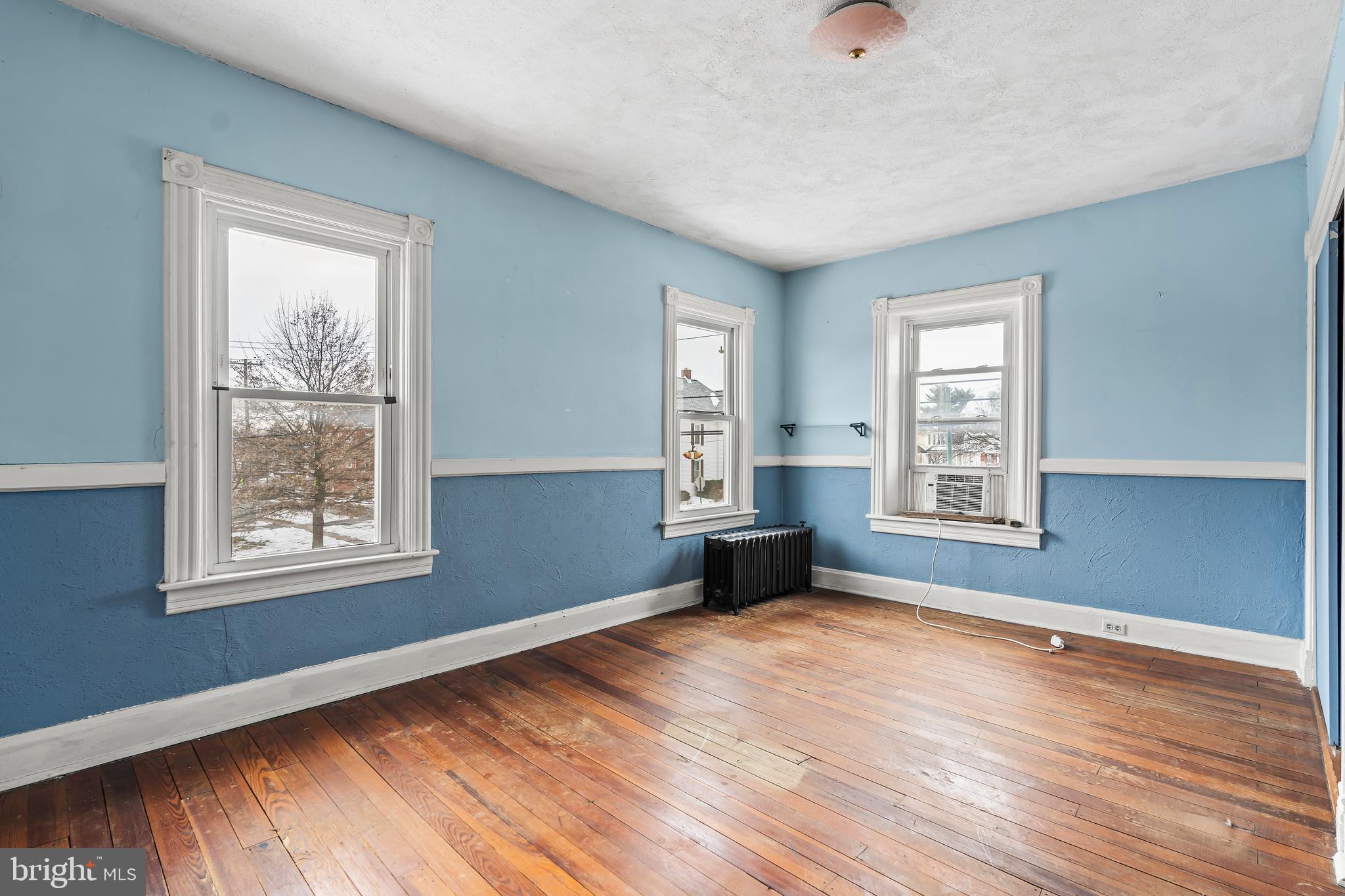 767 Spruce Street Hagerstown, MD 21740 - Photo 26 of 36 an empty room with wooden floor and windows
