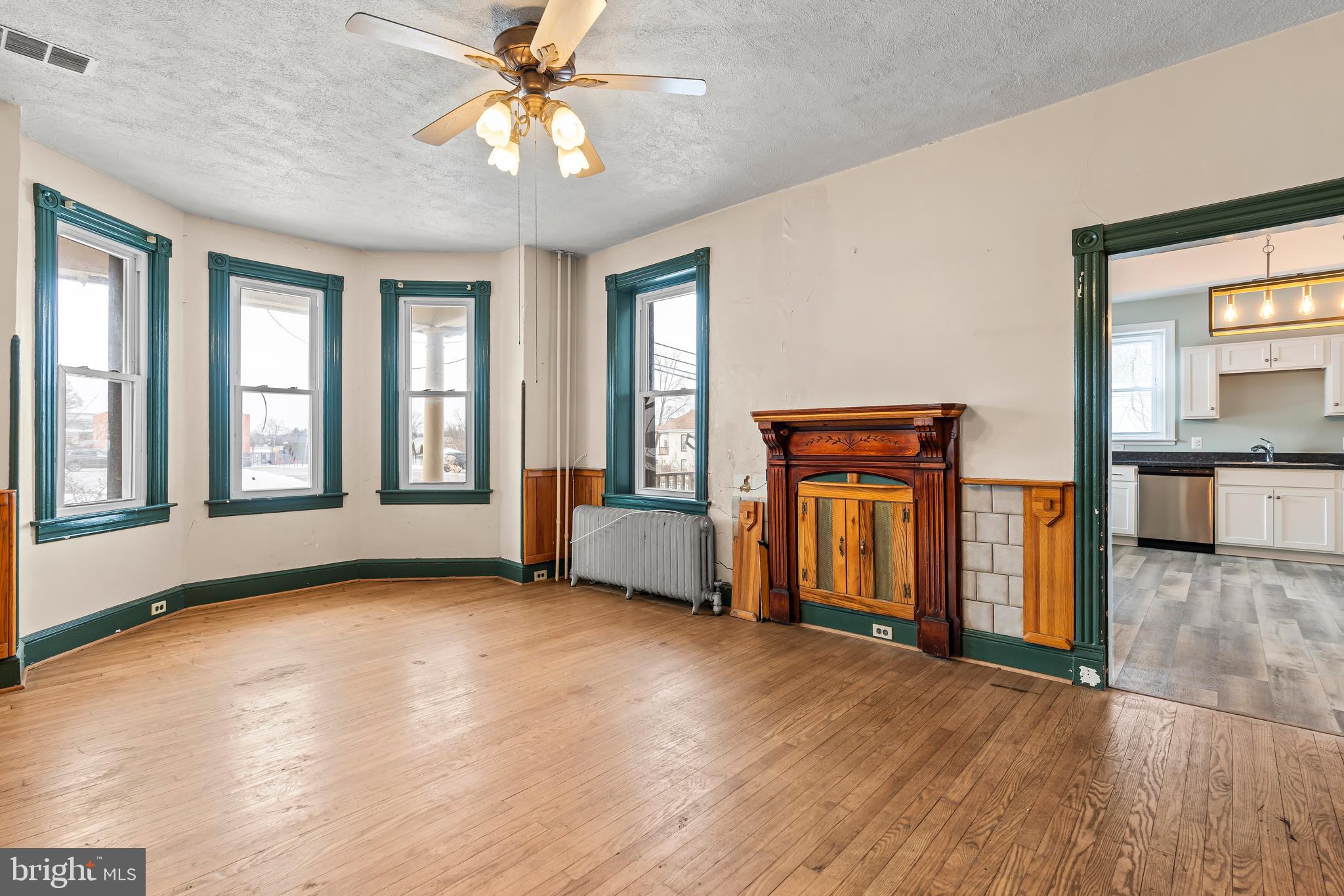 767 Spruce Street Hagerstown, MD 21740 - Photo 7 of 36 a view of an empty room with window and wooden floor