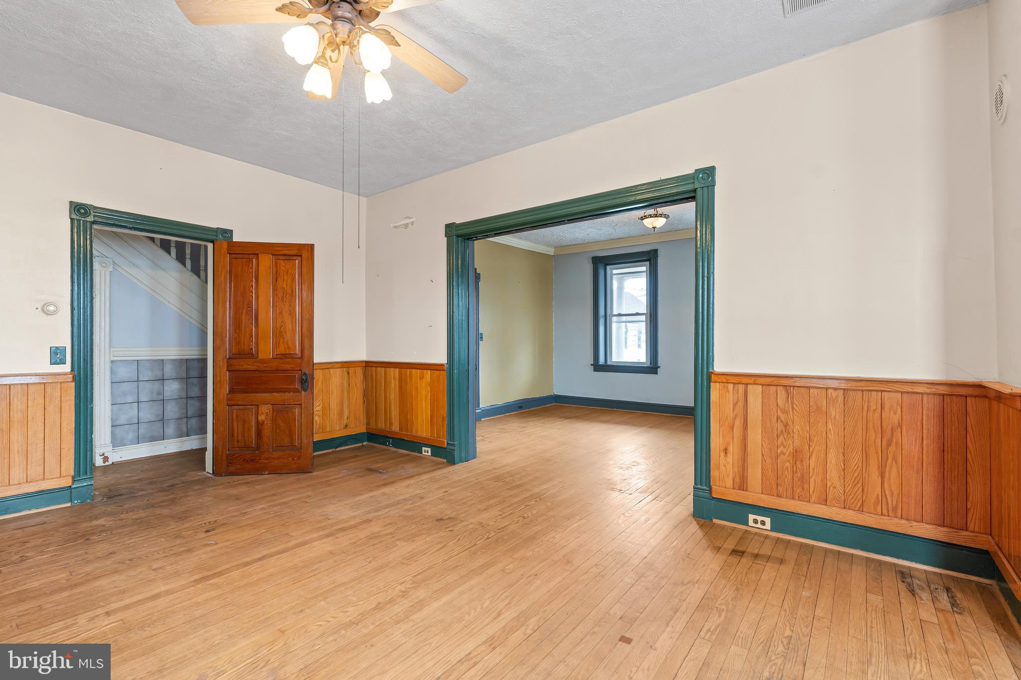 767 Spruce Street Hagerstown, MD 21740 - Photo 8 of 36 a view of a livingroom with wooden floor and a ceiling fan