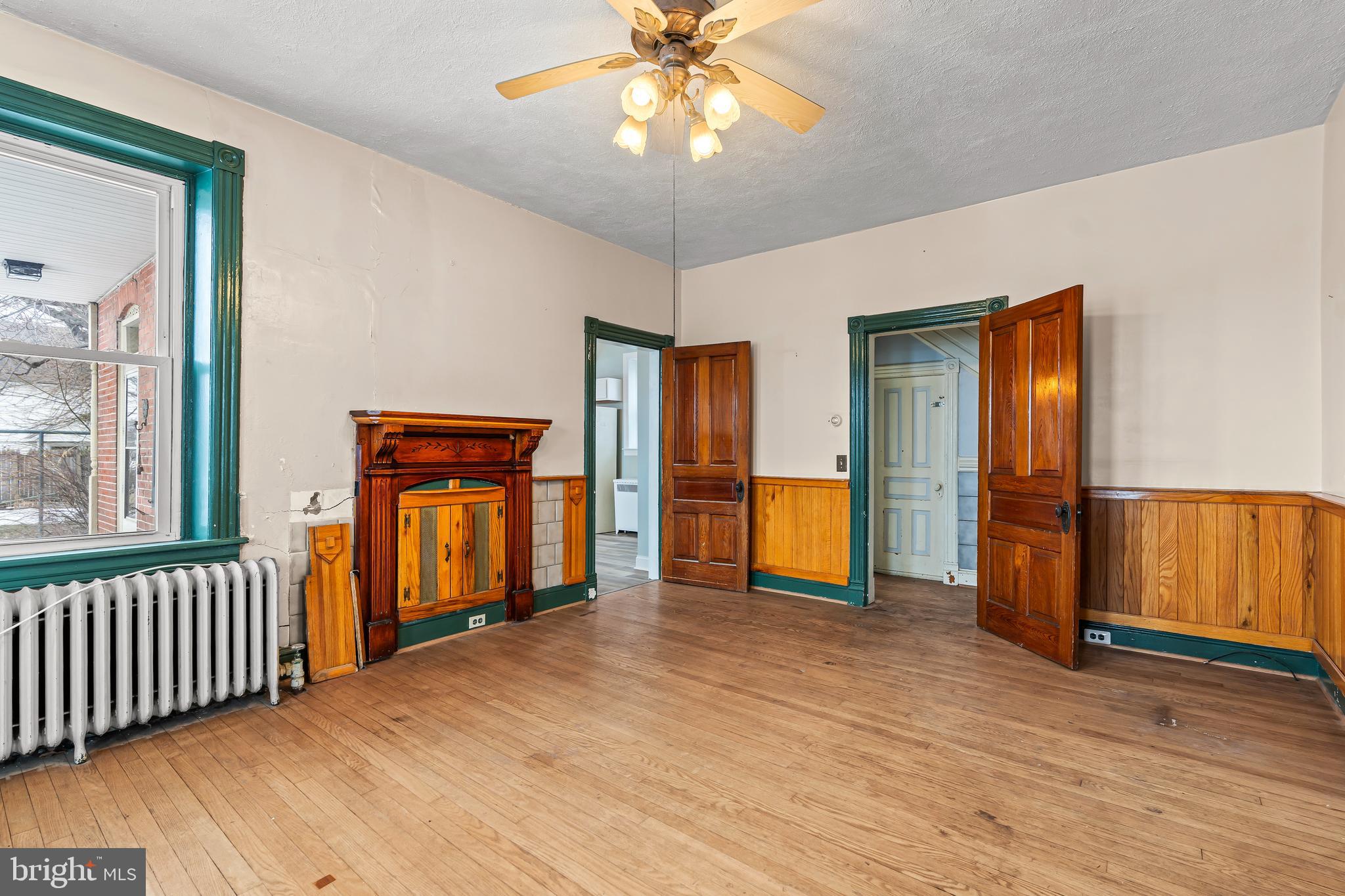 767 Spruce Street Hagerstown, MD 21740 - Photo 9 of 36 a view of an empty room with window and wooden floor