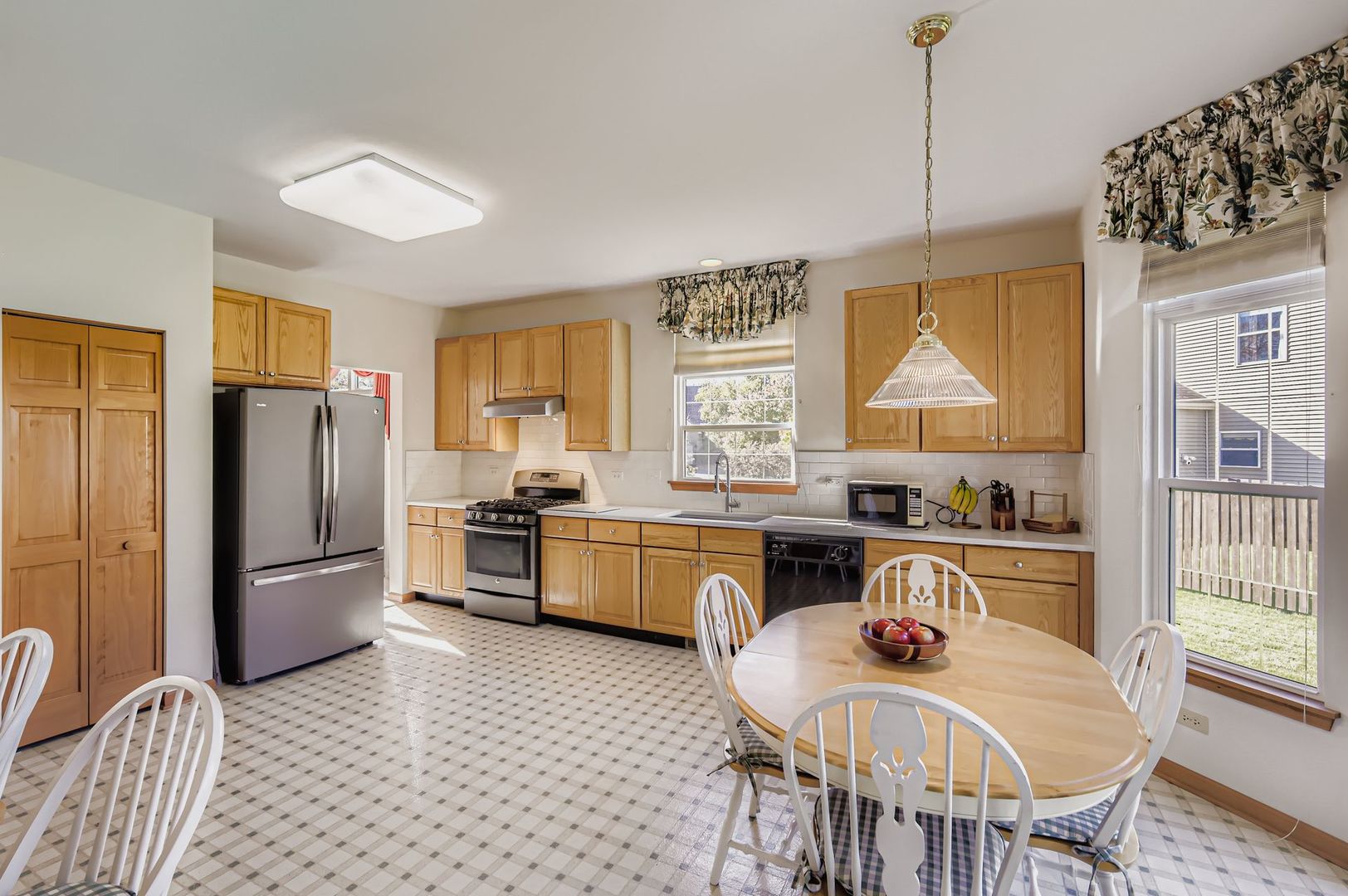1920 Butler Drive Bartlett, IL 60103 - Photo 10 of 27 a kitchen with stainless steel appliances granite countertop a stove a refrigerator a kitchen island a dining table and chairs