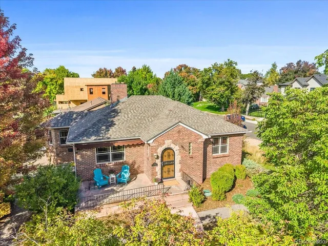 a aerial view of a house with a yard and potted plants