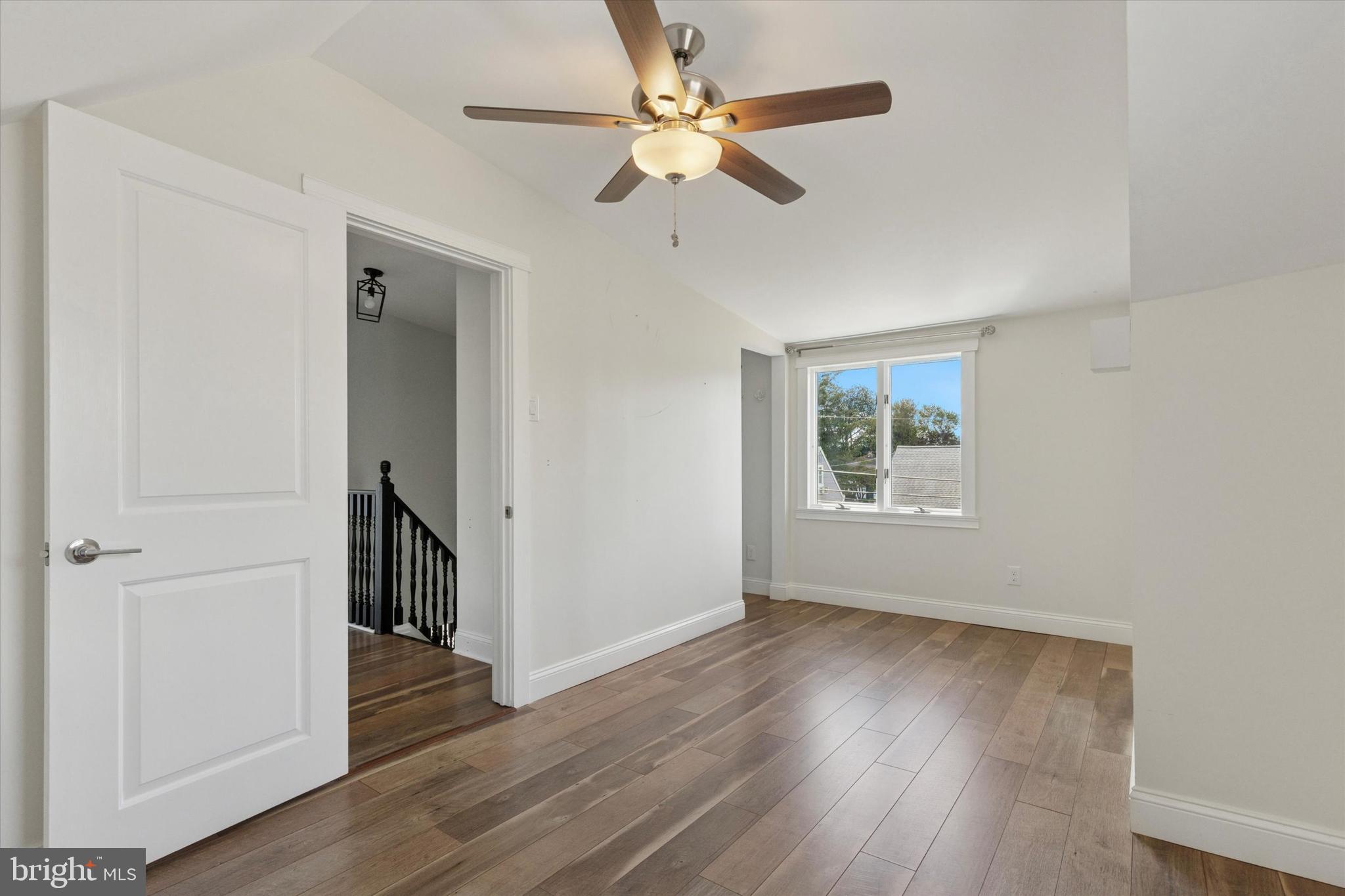 404 Exton Road Hatboro, PA 19040 - Photo 13 of 25 an empty room with wooden floor chandelier fan and windows