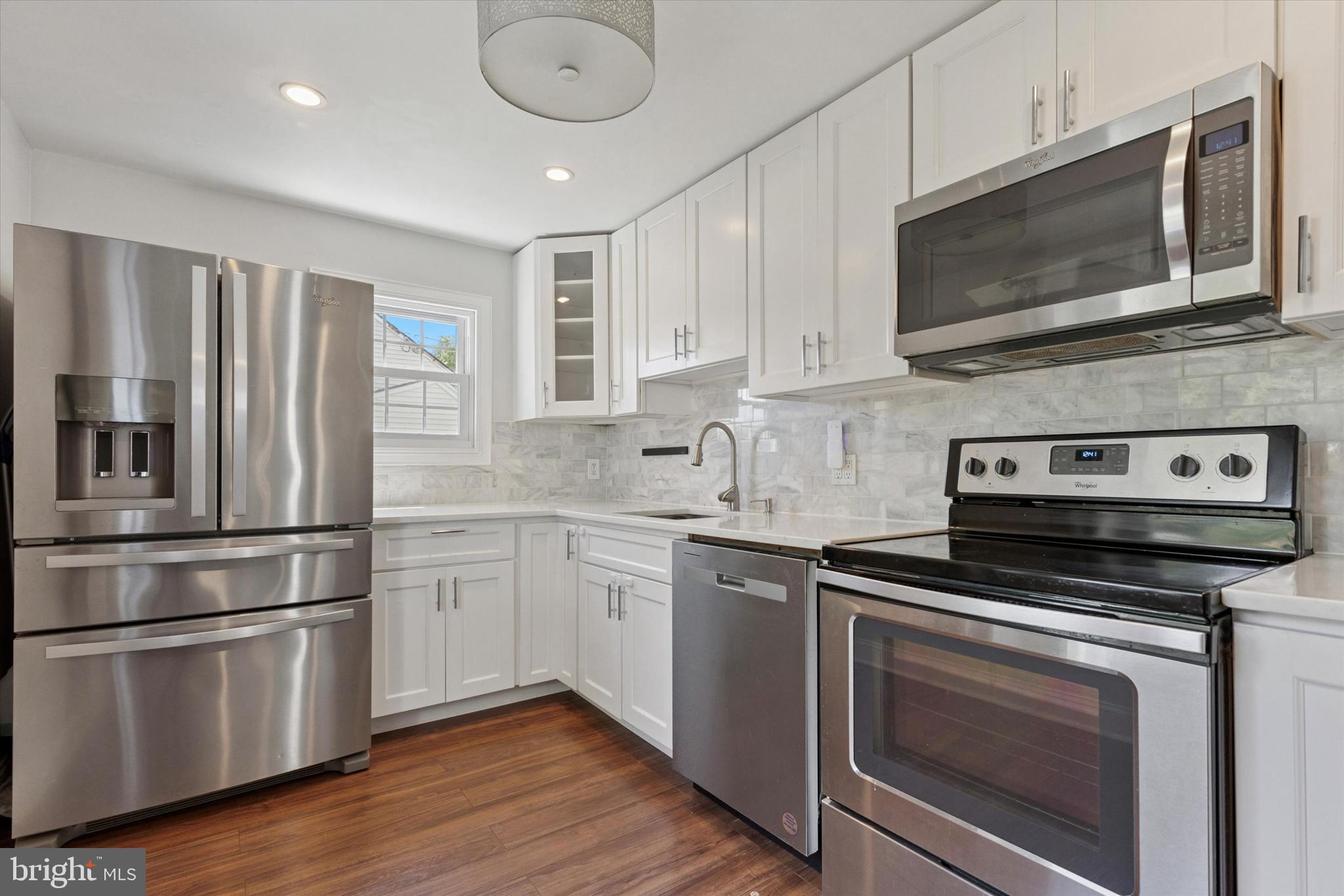 404 Exton Road Hatboro, PA 19040 - Photo 4 of 25 a kitchen with stainless steel appliances granite countertop a stove microwave and sink
