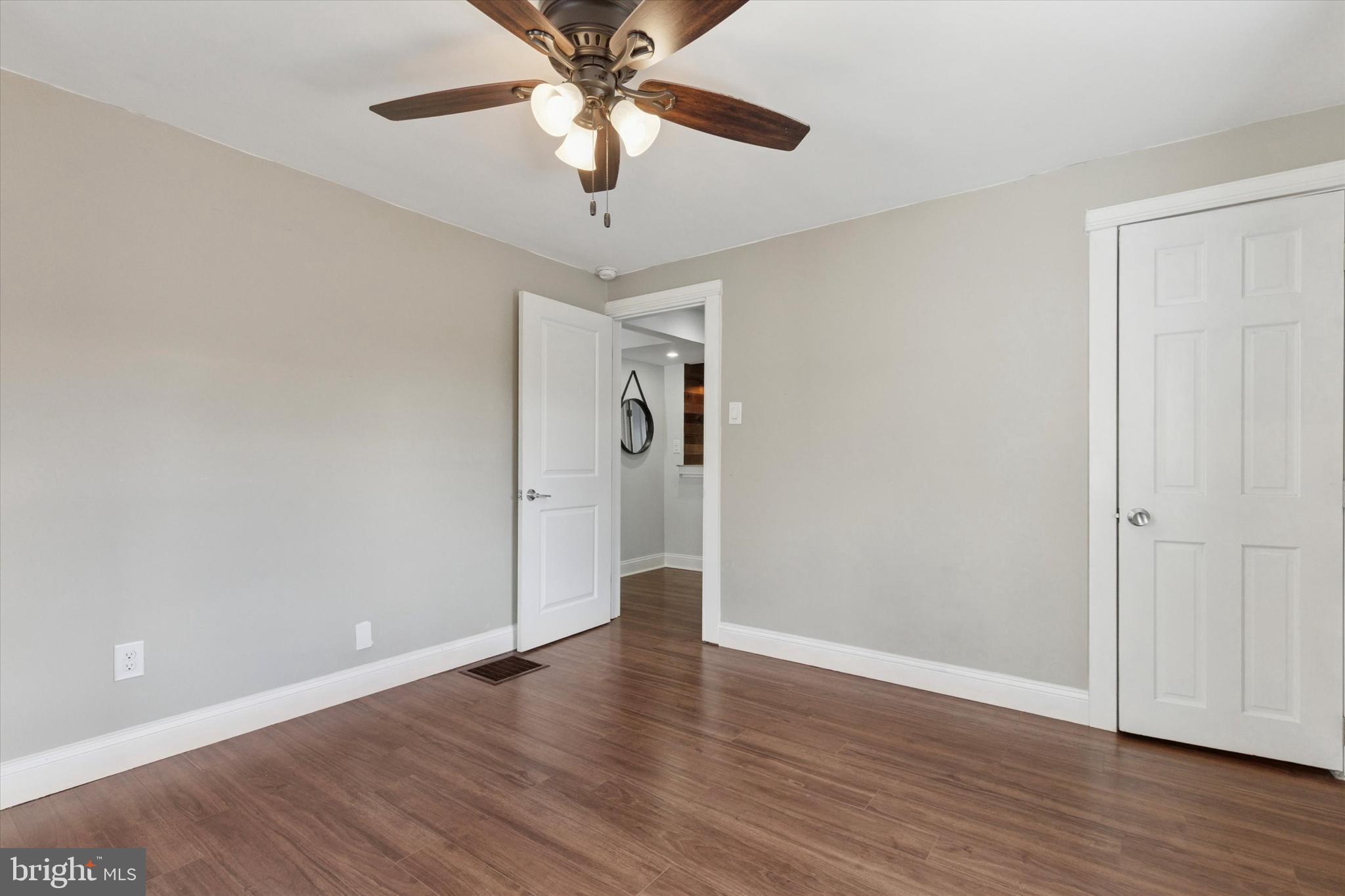 404 Exton Road Hatboro, PA 19040 - Photo 10 of 25 an empty room with wooden floor chandelier fan and closet area