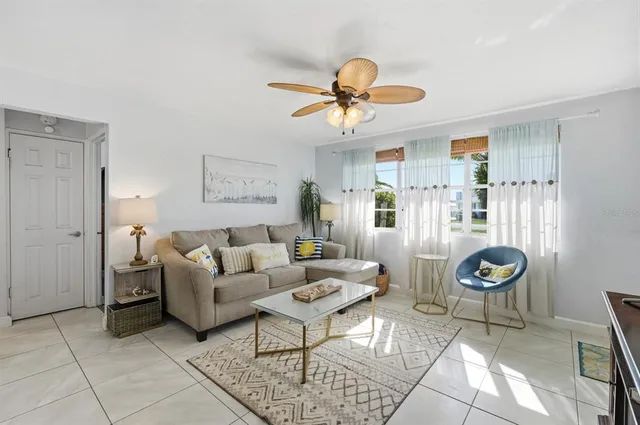 a living room with furniture a rug and white walls