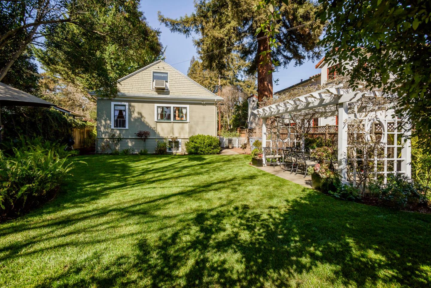 466 Ruthven Avenue Palo Alto, CA 94301 - Photo 7 of 12 a front view of a house with a garden