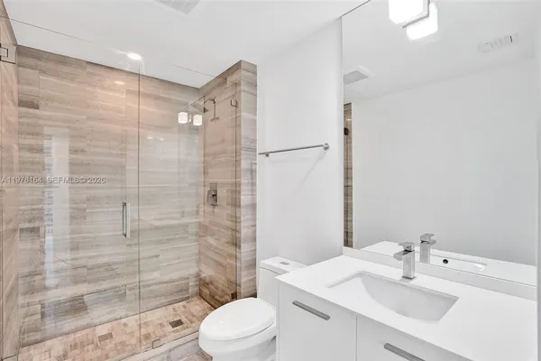 a bathroom with a sink toilet and shower