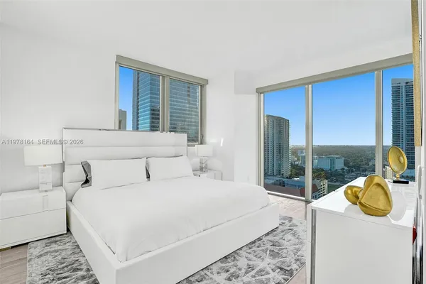 a bedroom with bed and glass door