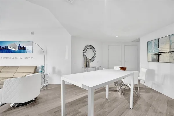 a view of a dining room that has a table and chairs in it