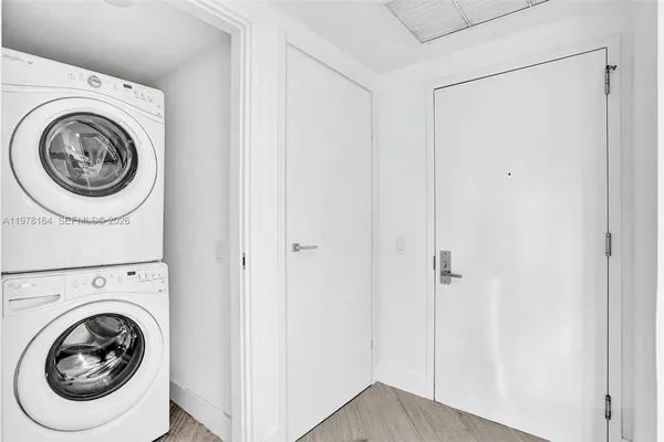 a view of a hallway with washer and dryer