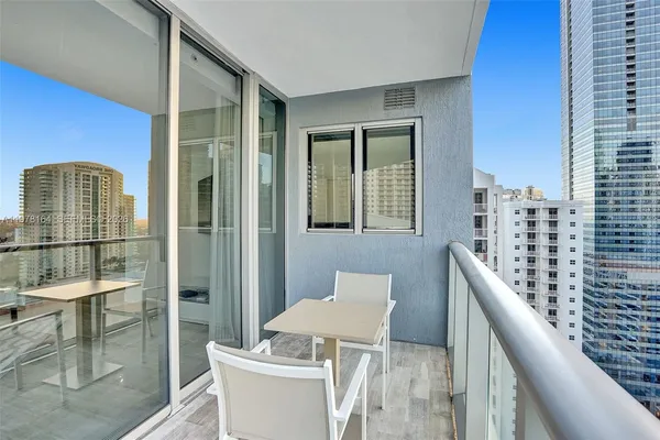 a balcony with table and chairs